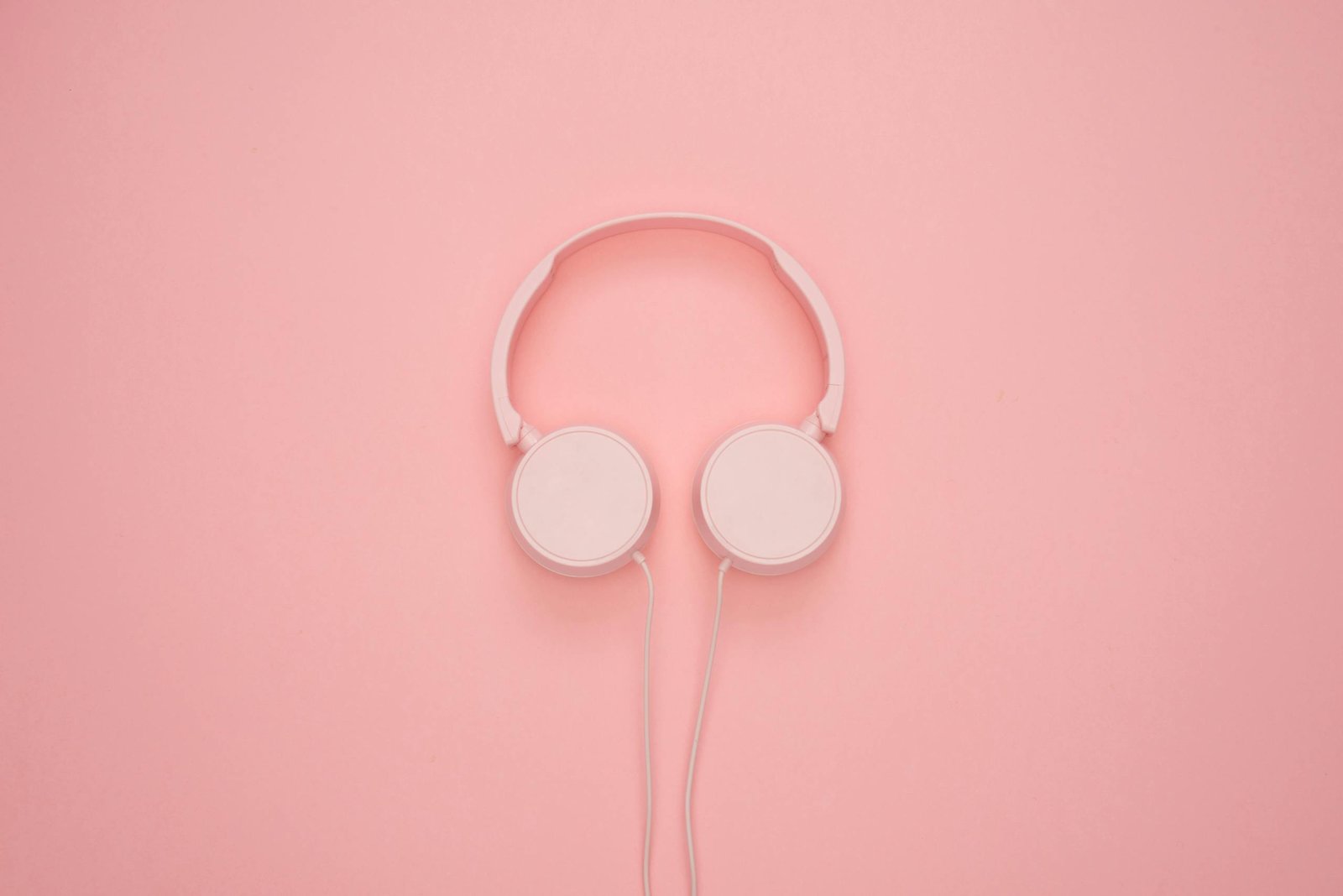 Aesthetic pink headphones on a pastel background, perfect for a modern and stylish look.